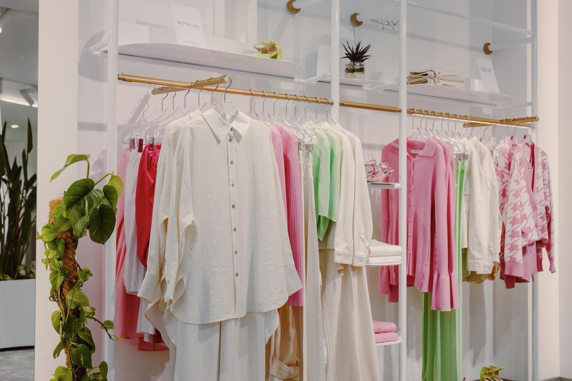 variety of silk blouses displayed on hangers