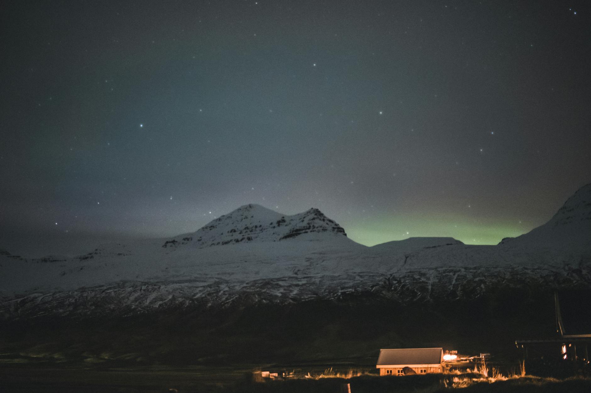 Northern Lights over a snowy landscape in Iceland