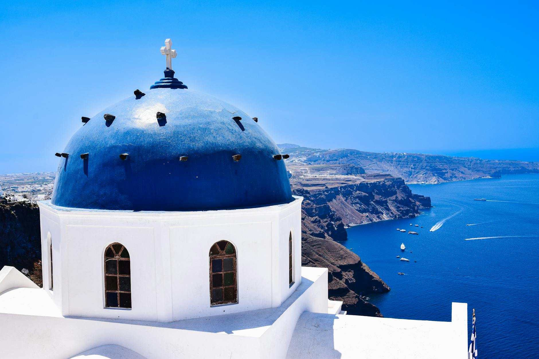 aerial view of Santorini, Greece with white buildings and blue domes