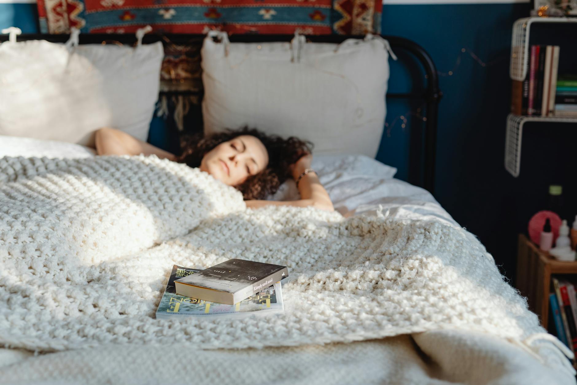 a person reading a book in a cozy bed before sleeping