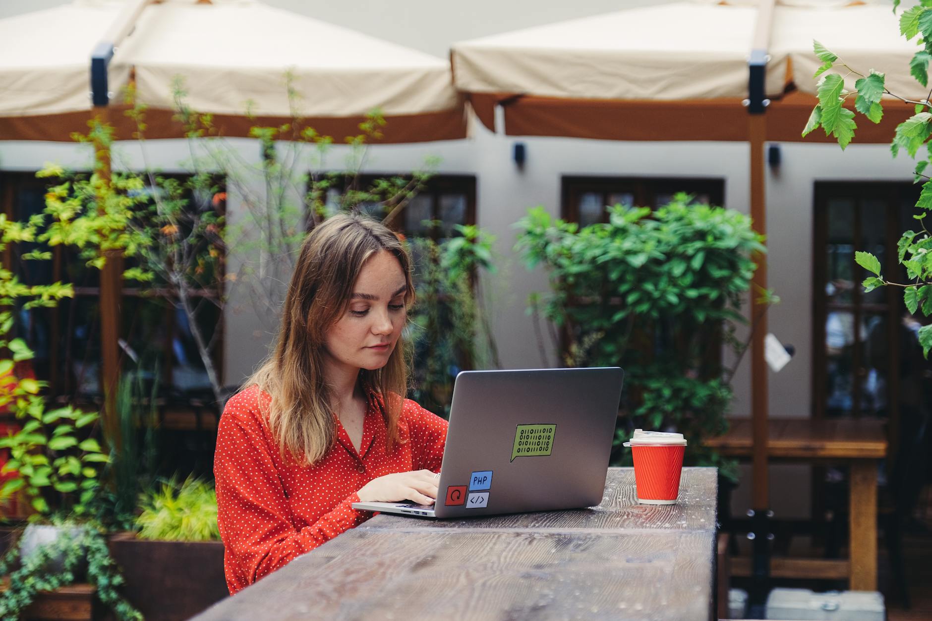 A young entrepreneur working from a cafe, showcasing digital tools