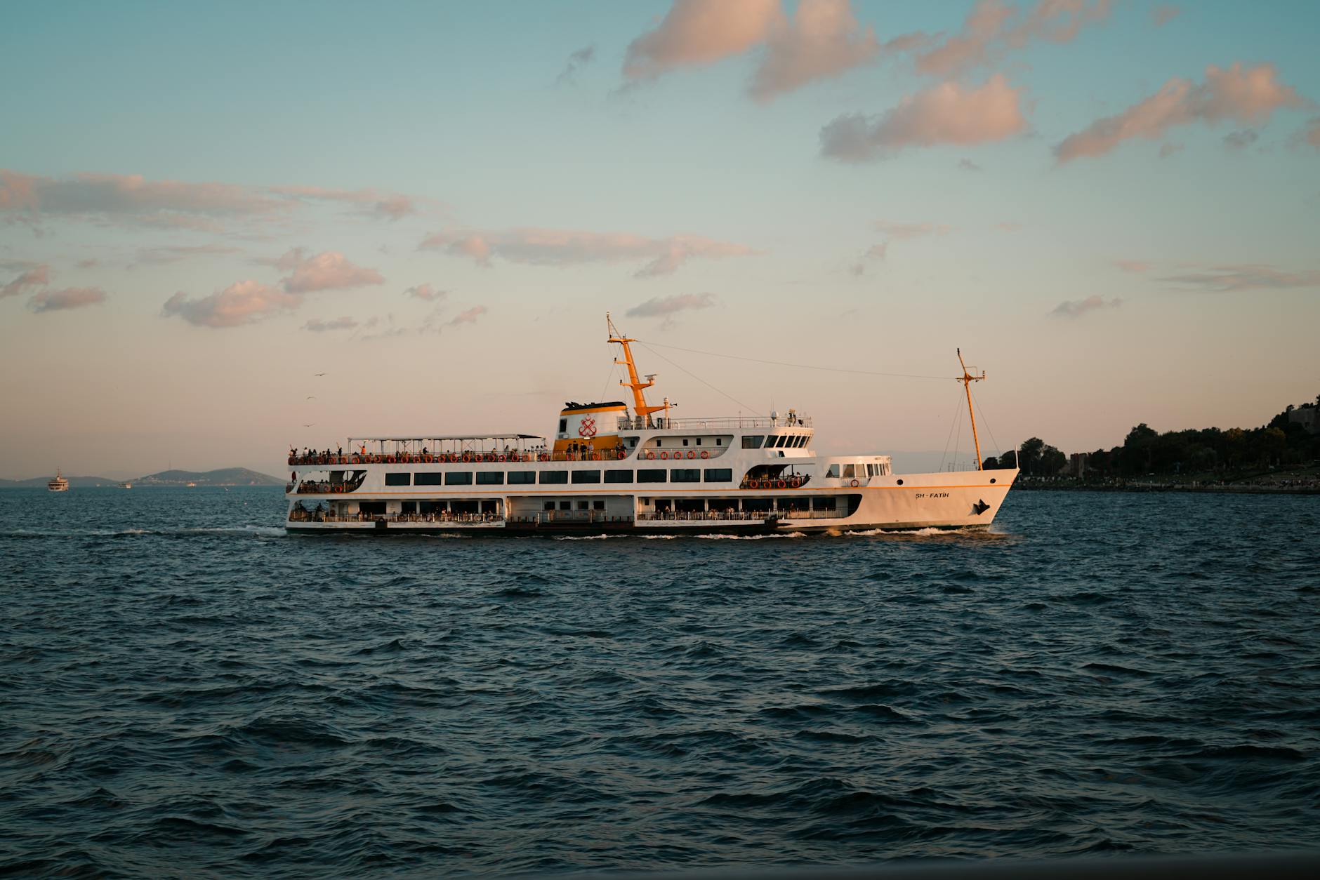 cruise ship sailing at sunset