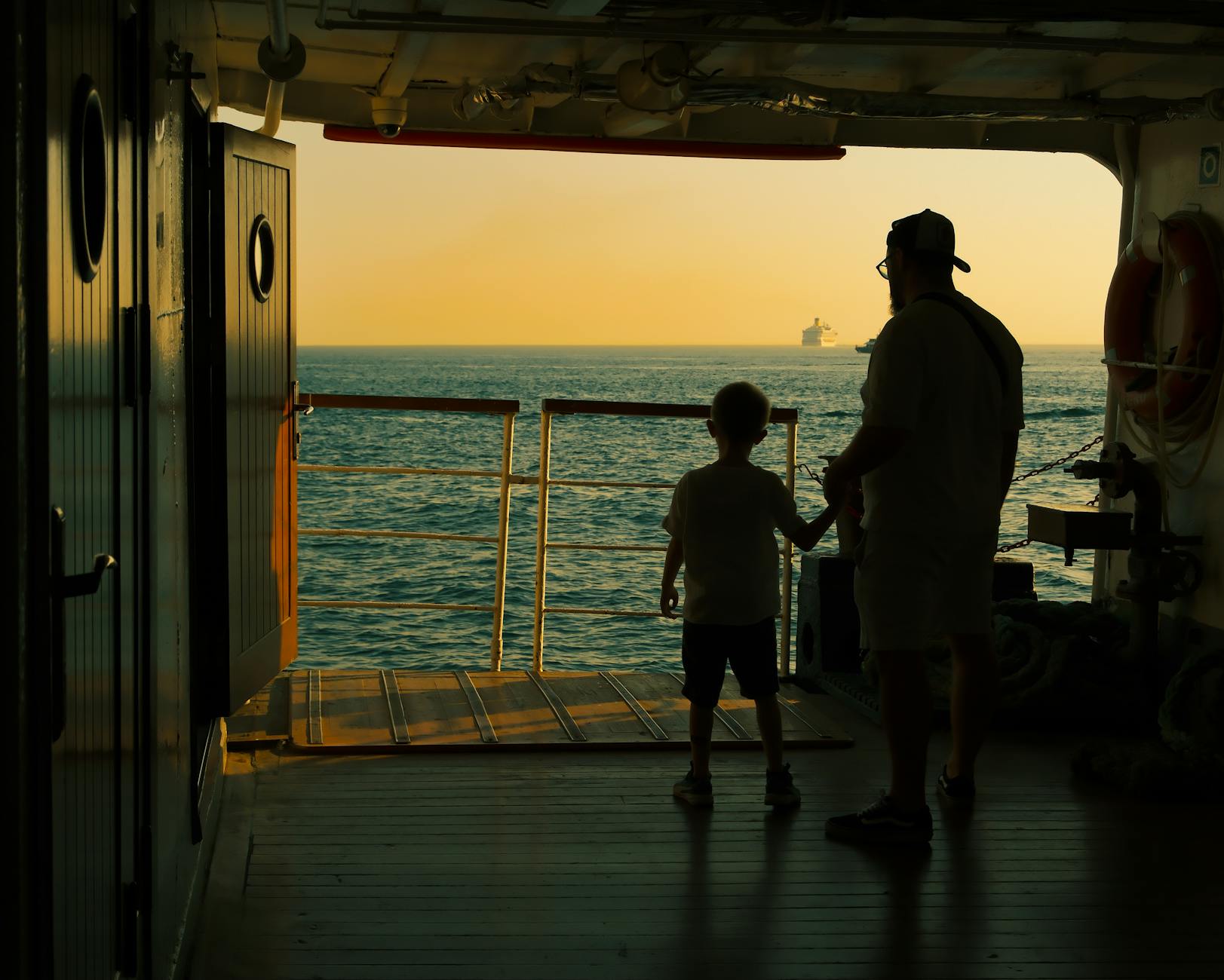 happy family on a cruise ship deck enjoying sunset
