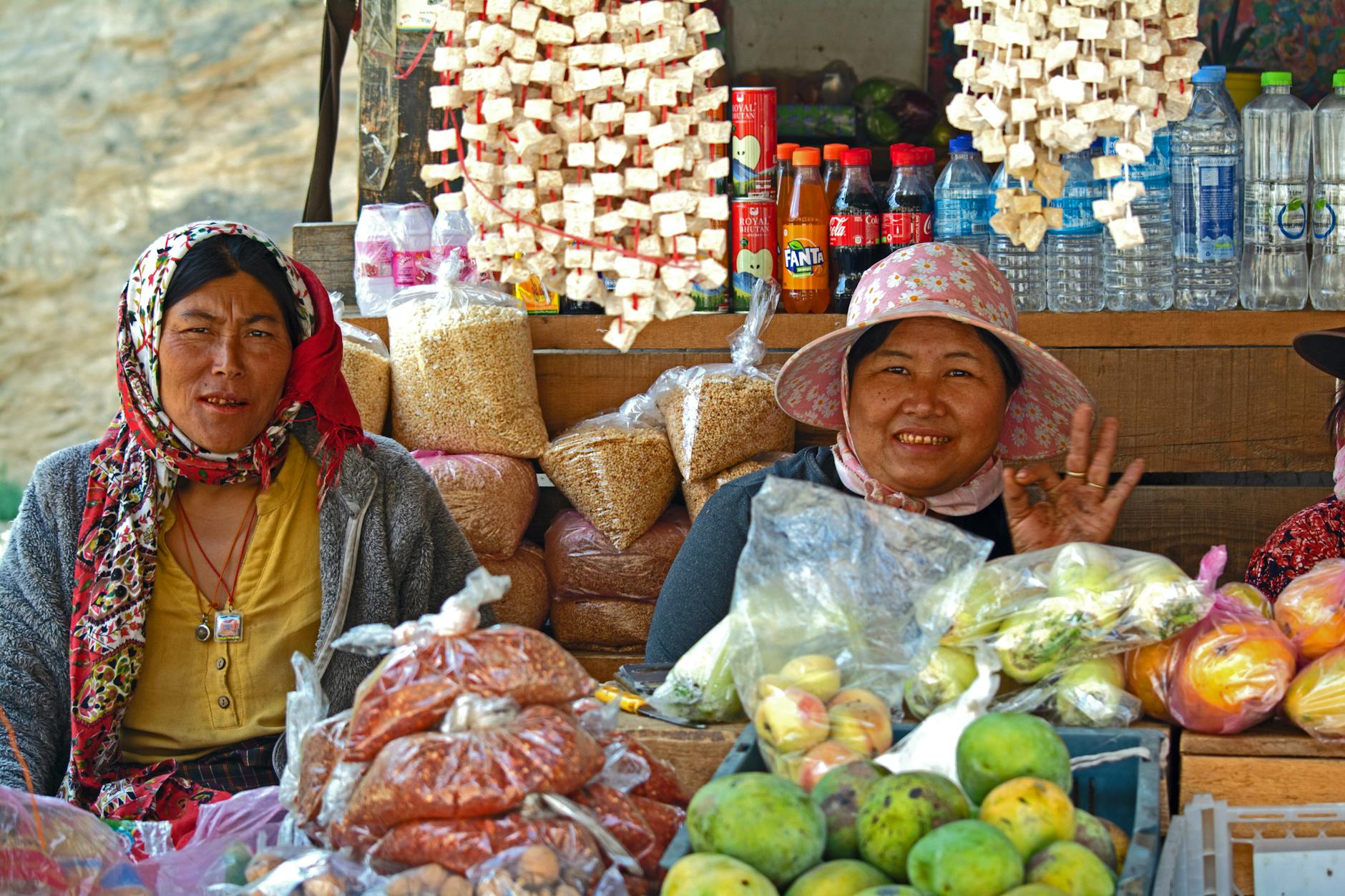A group of smiling locals in a market in Bhutan, showcasing kindness and community spirit