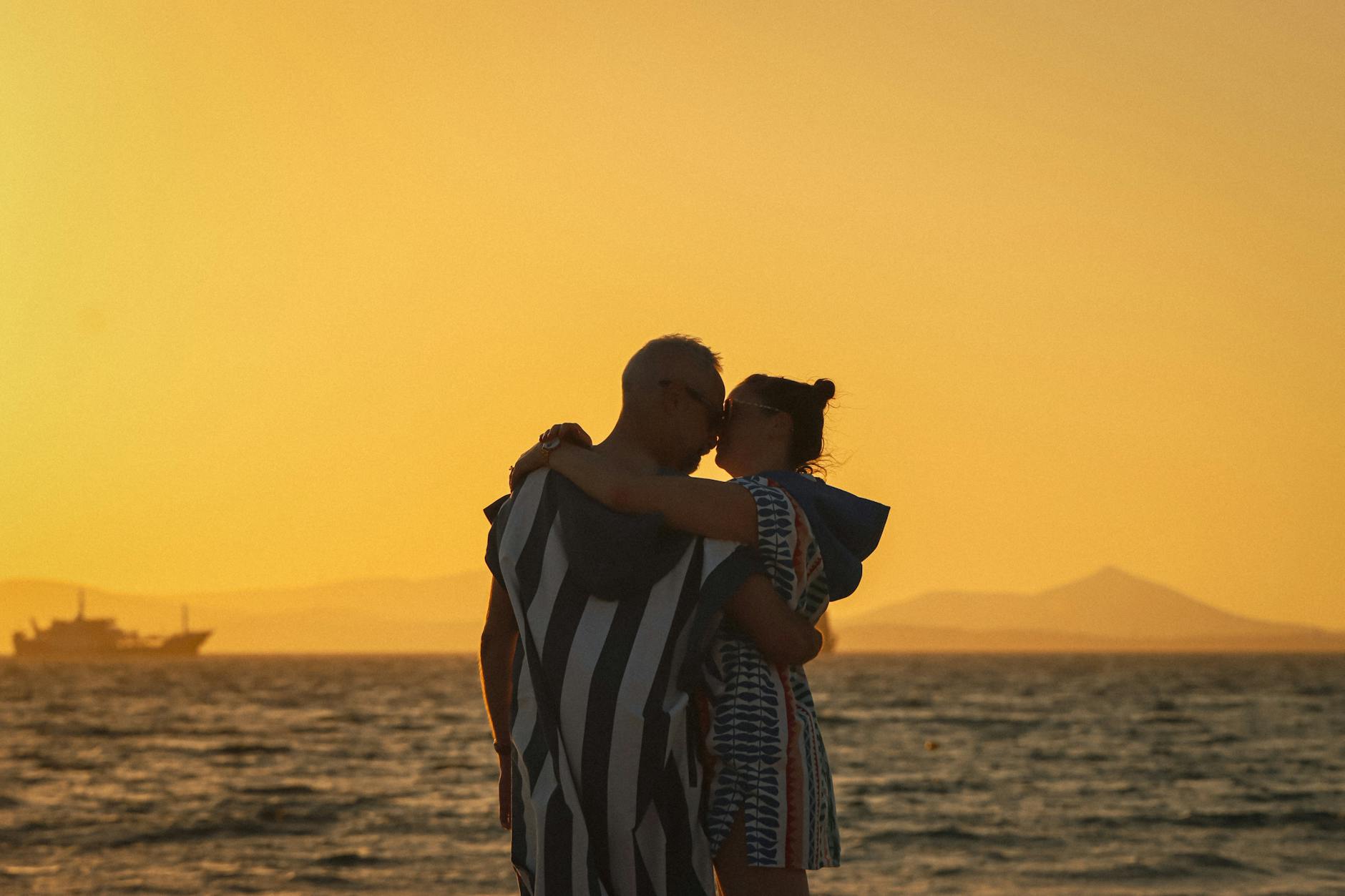 couple enjoying sunset on a beach