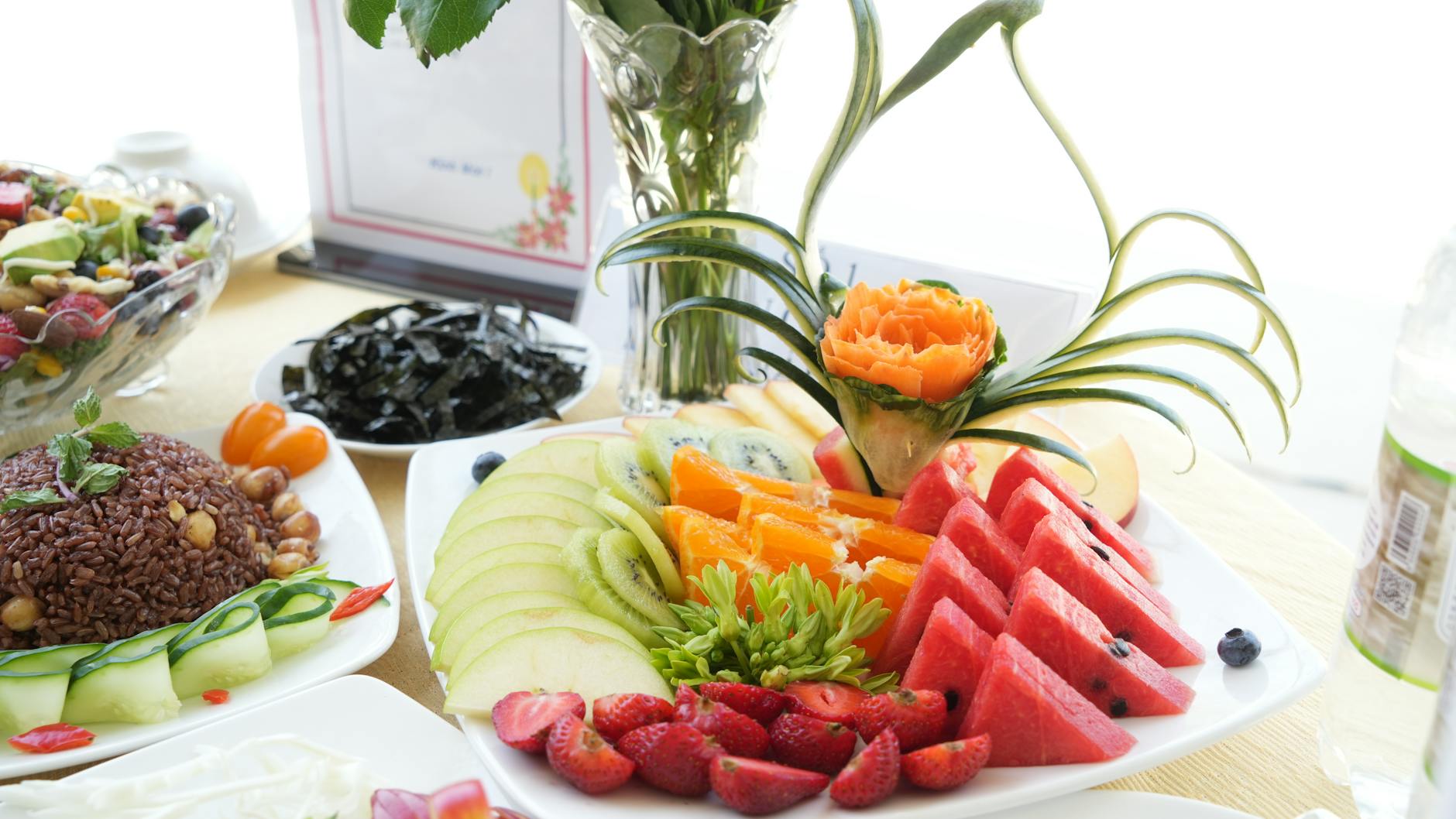 monkeys enjoying a buffet of fruits and vegetables