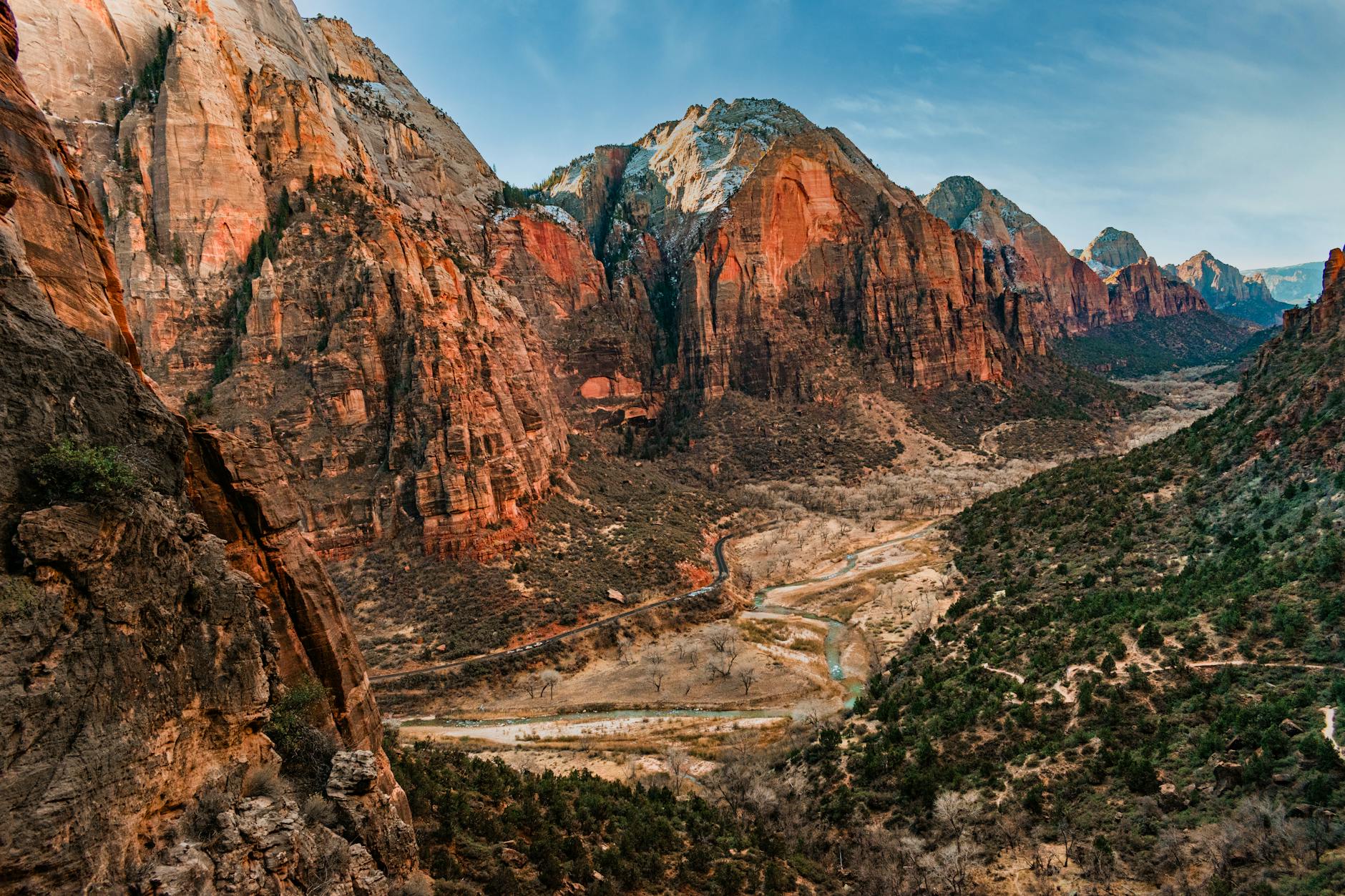 tranquil scene in Zion National Park with red rock formations and lush greenery