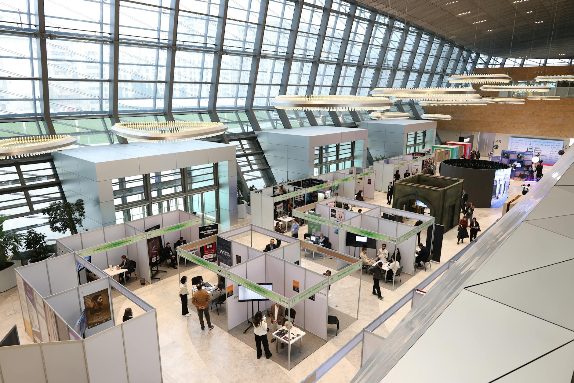 An art fair bustling with activity, showcasing modern art exhibits and attendees in elegant attire.