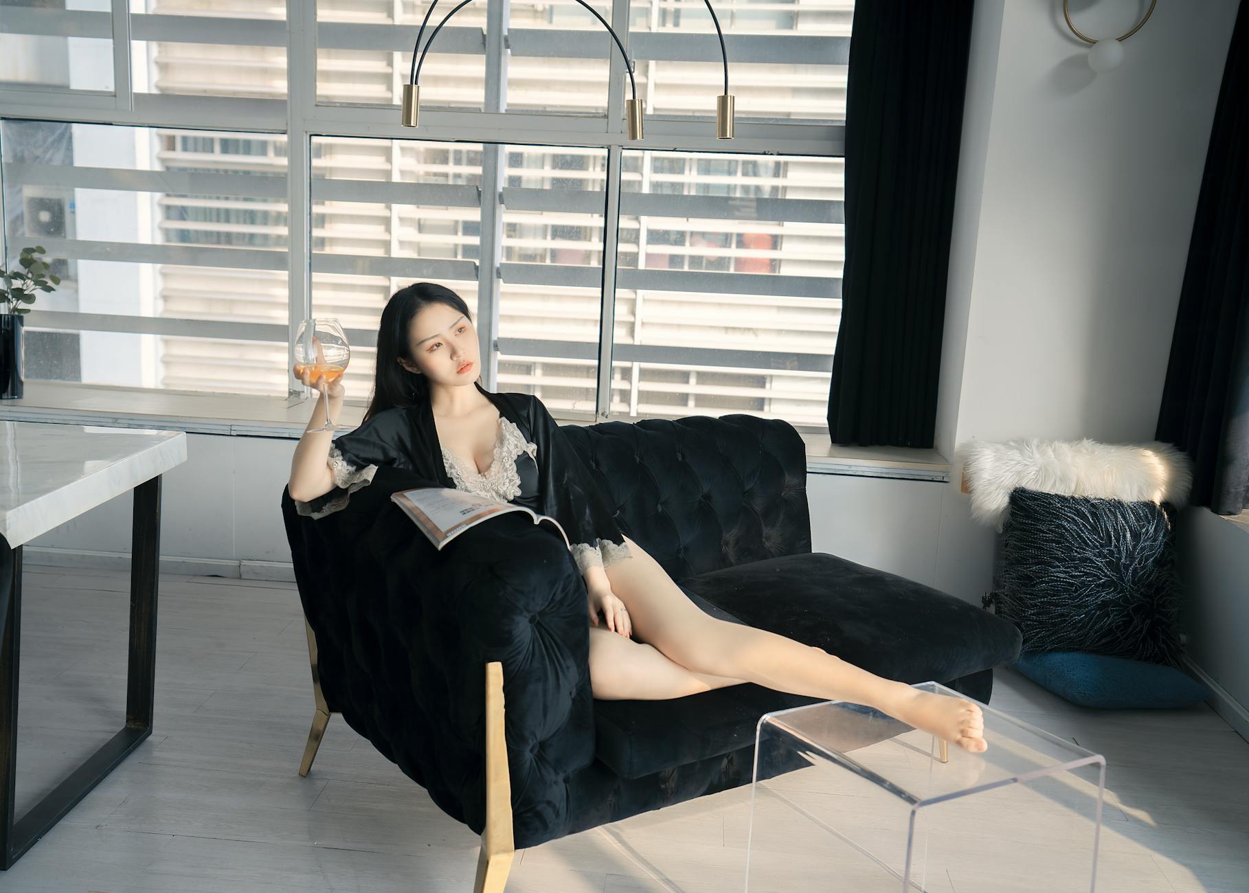 person relaxing in luxury sleepwear on a sofa