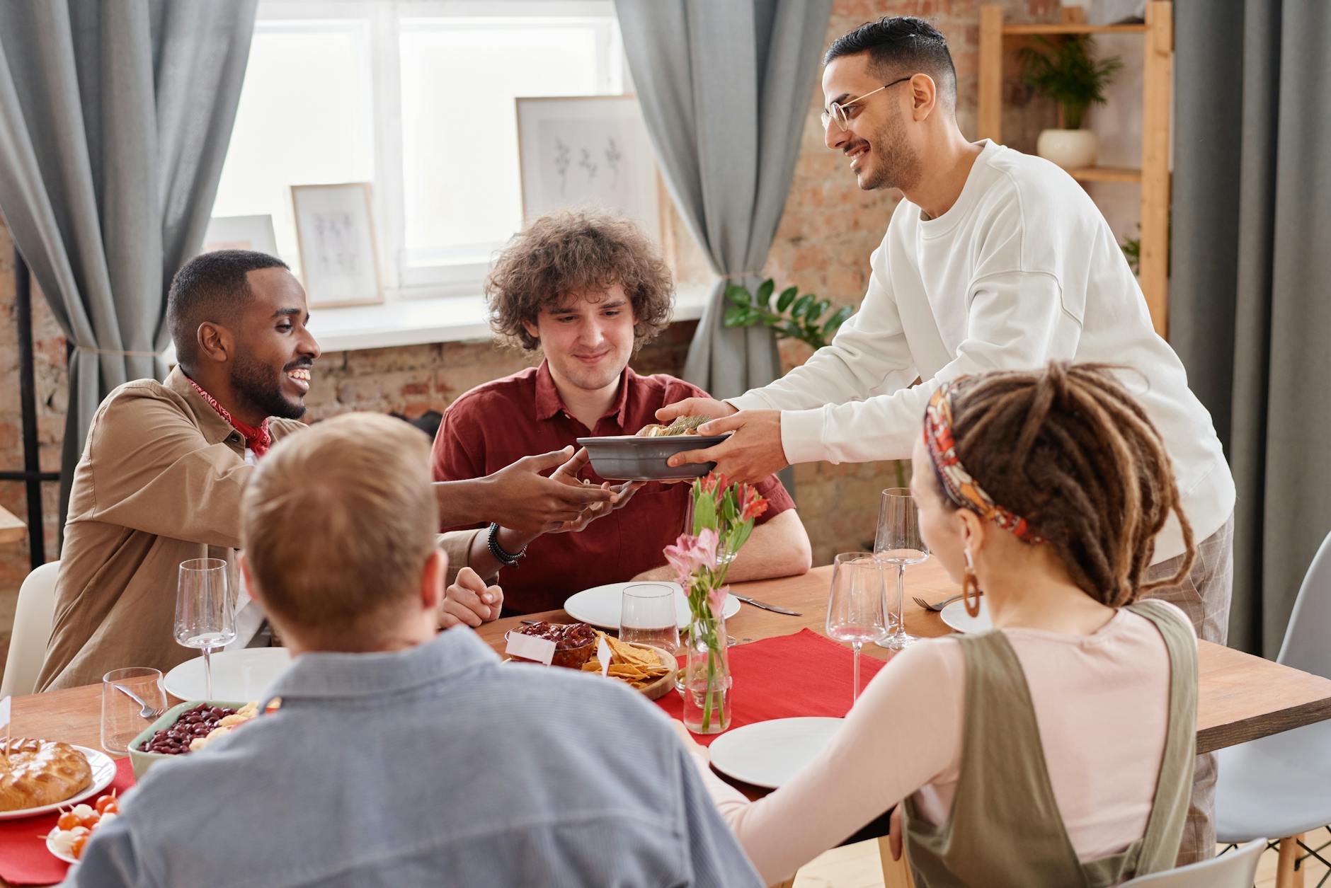 friends sharing a meal and expressing gratitude