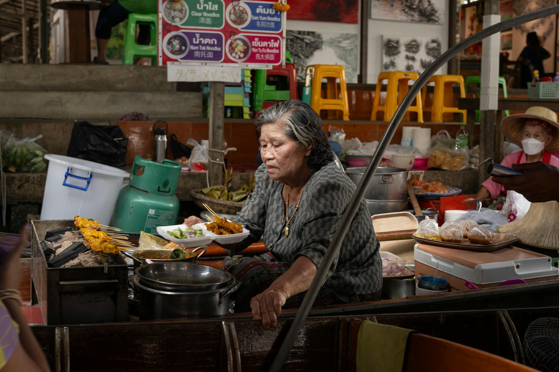 street food vendor in Bangkok with customers enjoying local delicacies