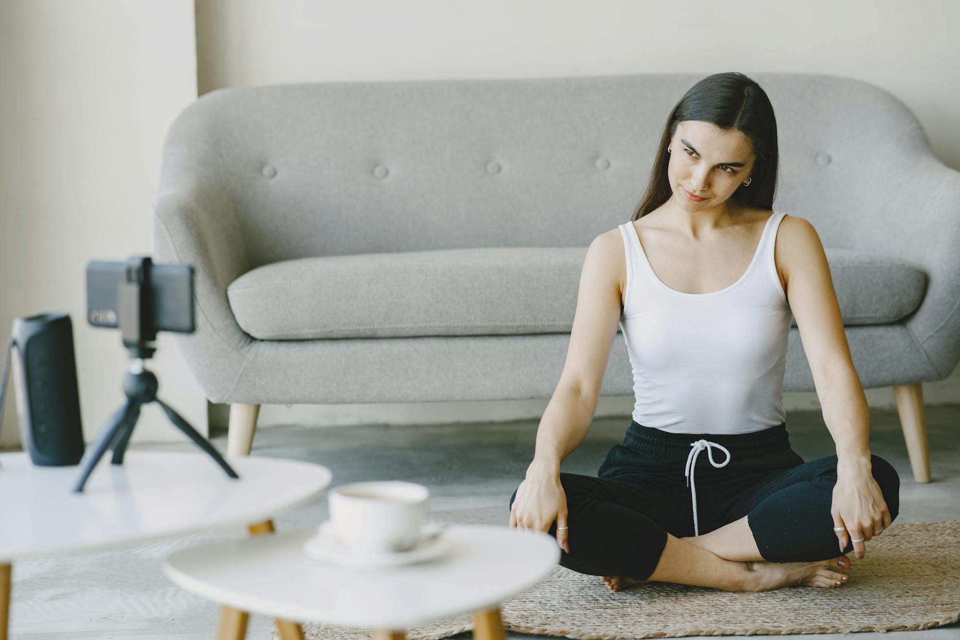 person meditating with smartphones in background
