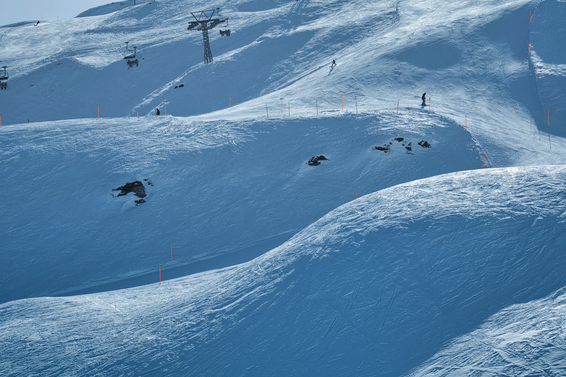 snowy mountain landscape with skiers